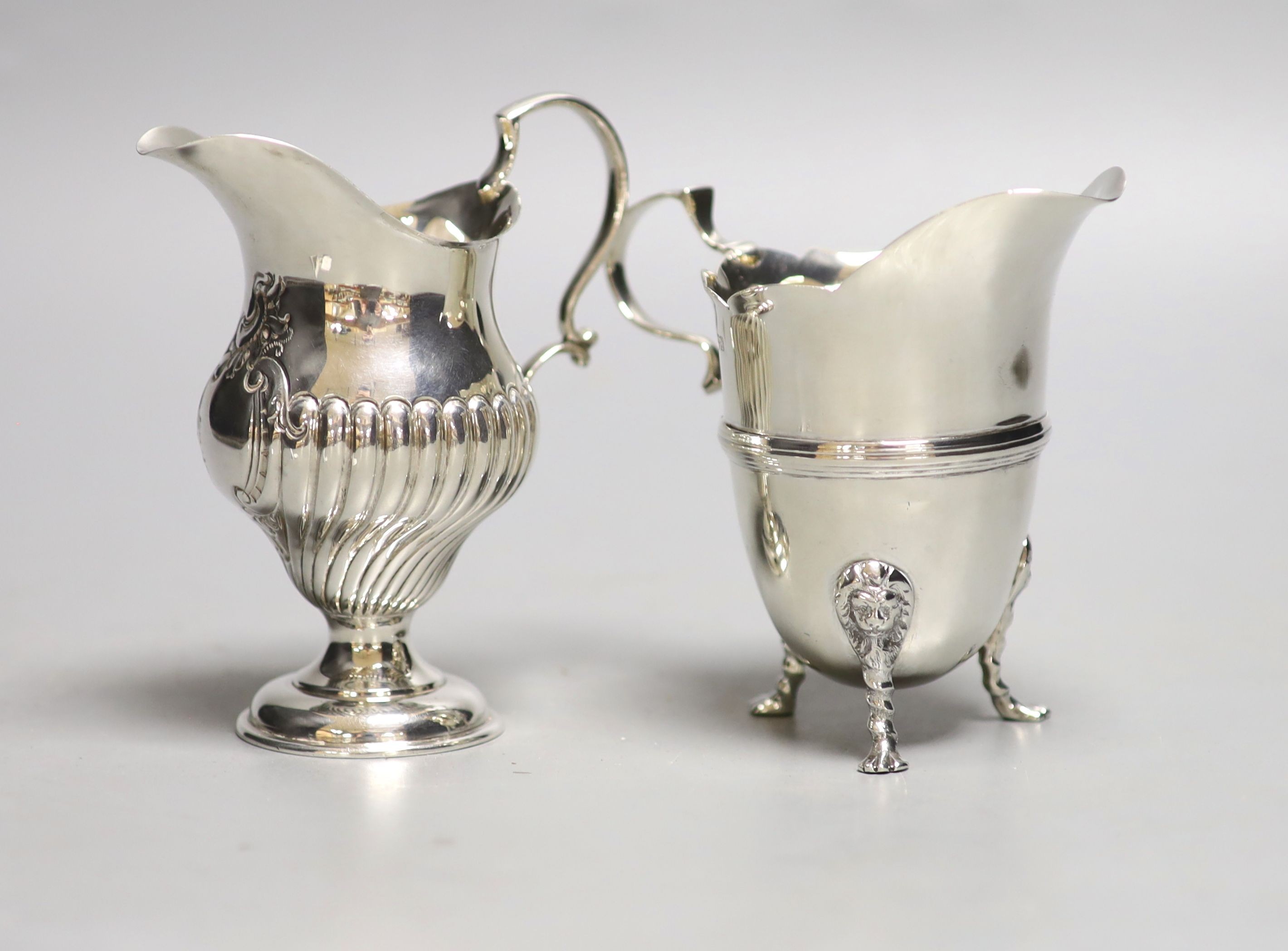 A late Victorian silver inverted pear shaped cream jug, Birmingham, 1894, 10.6cm, and a later silver cream jug, 8oz.